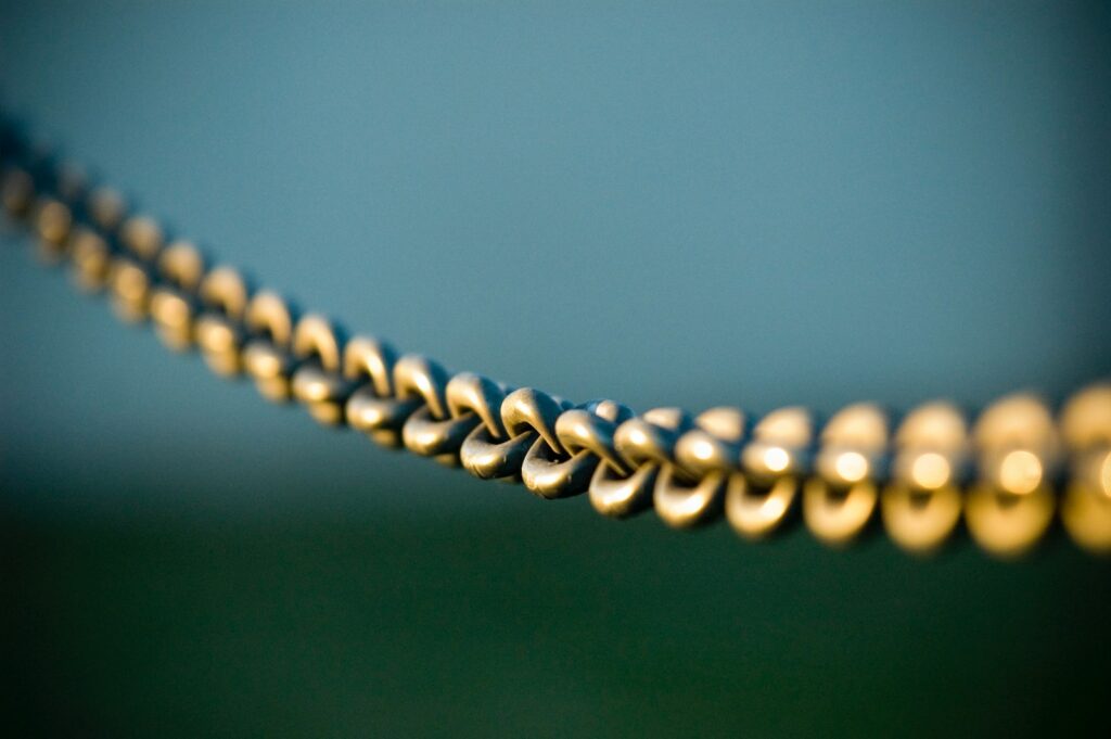 tilt shift photography of gray steel chains